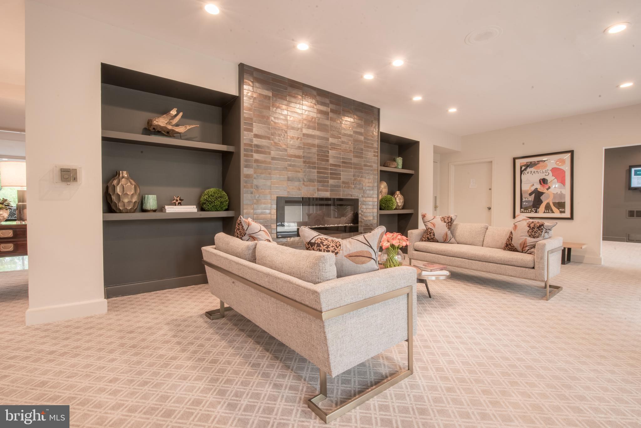 11 Slade Avenue, Unit 410 Pikesville, MD 21208 - Photo 27 of 32 a living room with furniture and a fireplace