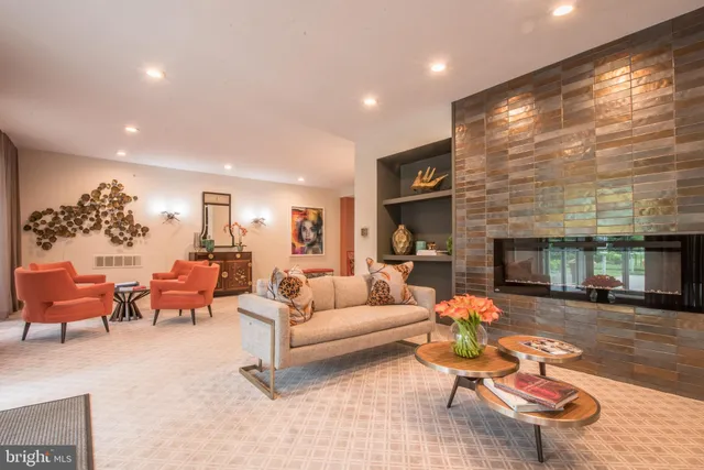 a living room with furniture and a fireplace