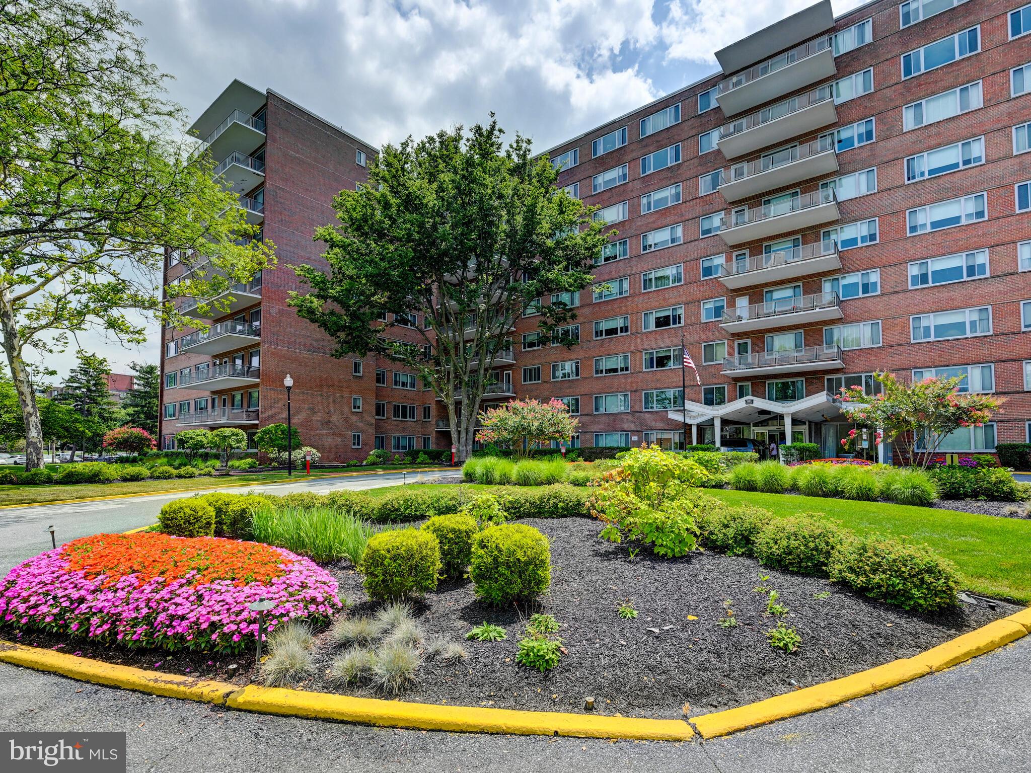 11 Slade Avenue, Unit 410 Pikesville, MD 21208 - Photo 30 of 32 a view of a big building with a big yard and large trees