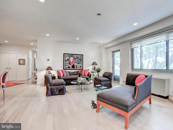 a living room with furniture kitchen and a table