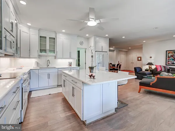 a large kitchen with cabinets a sink and appliances in it