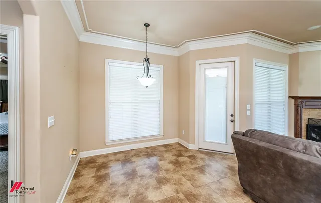 a view of a hallway with a chandelier fan