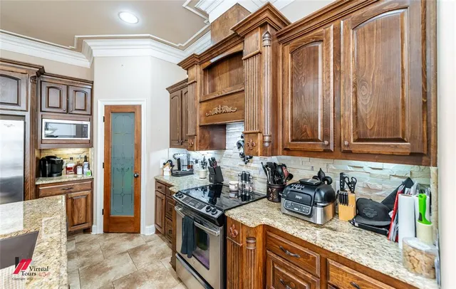 a kitchen with stainless steel appliances granite countertop a stove and a sink