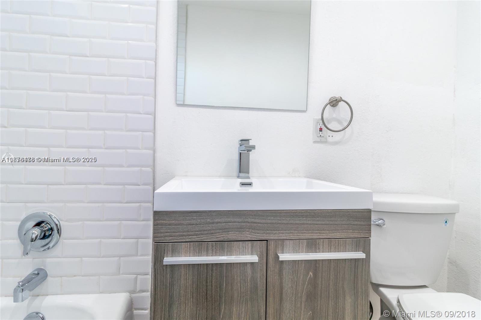 2201 Northeast 14th Avenue, Unit 3 Wilton Manors, FL 33305 - Photo 26 of 27 a bathroom with a sink and a toilet