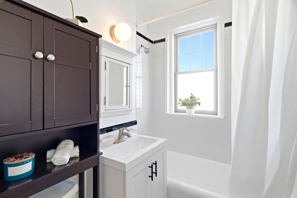 401 Washington Street, Unit 6 Brookline, MA 02446 - Photo 13 of 24 a bathroom with a sink vanity granite tub and shower