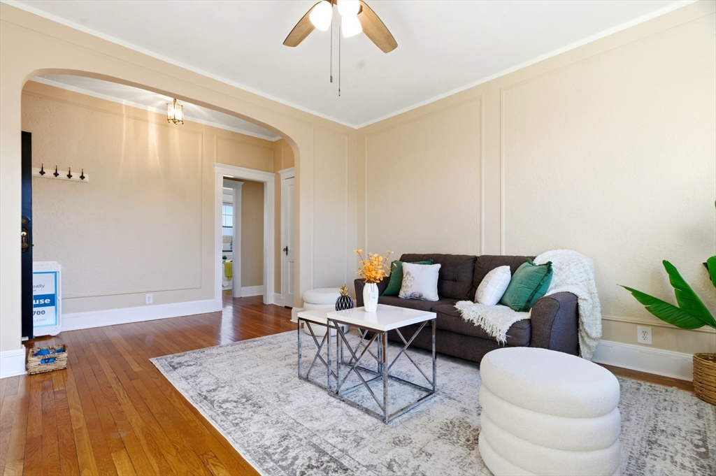 401 Washington Street, Unit 6 Brookline, MA 02446 - Photo 2 of 24 a living room with furniture and wooden floor