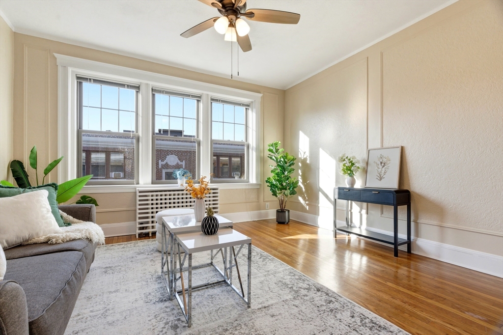 401 Washington Street, Unit 6 Brookline, MA 02446 - Photo 4 of 24 a living room with furniture and a wooden floor