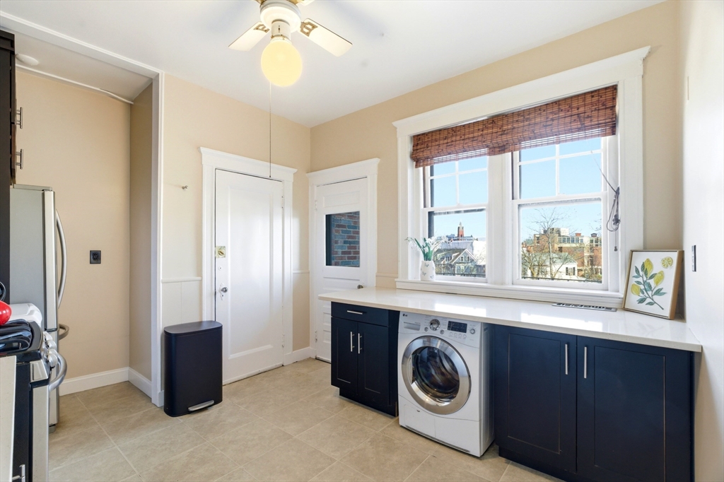 401 Washington Street, Unit 6 Brookline, MA 02446 - Photo 5 of 24 a view of a kitchen with washer and dryer