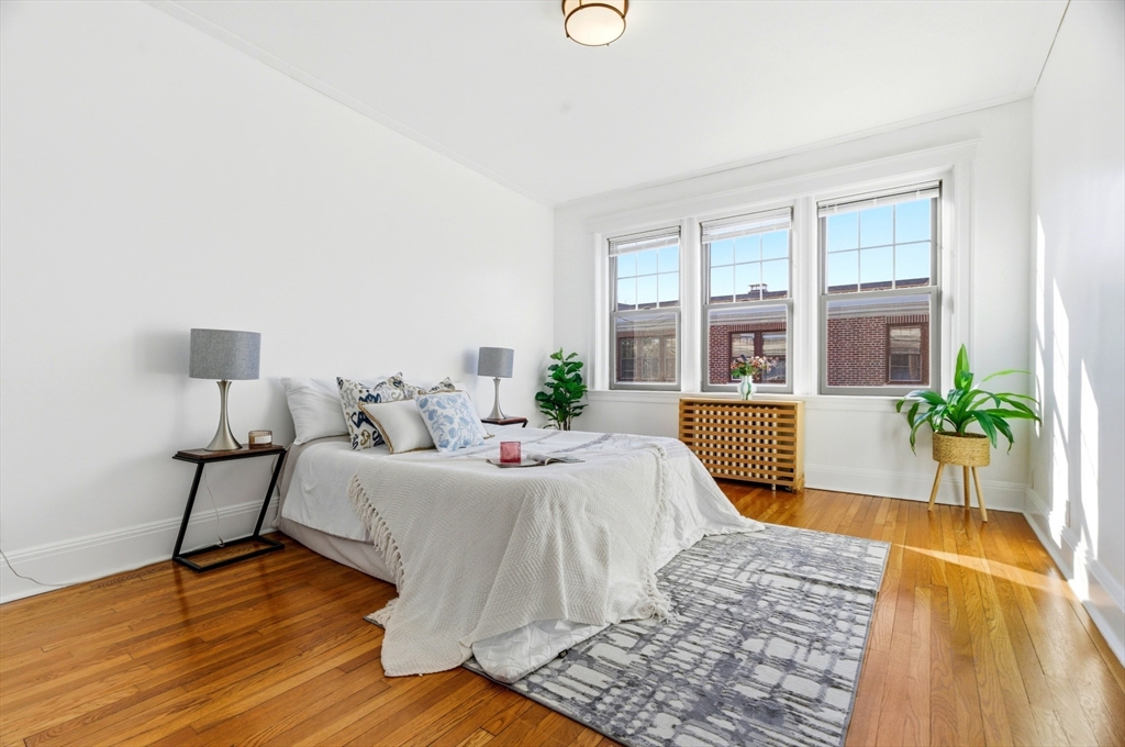401 Washington Street, Unit 6 Brookline, MA 02446 - Photo 9 of 24 a living room with furniture and a large window