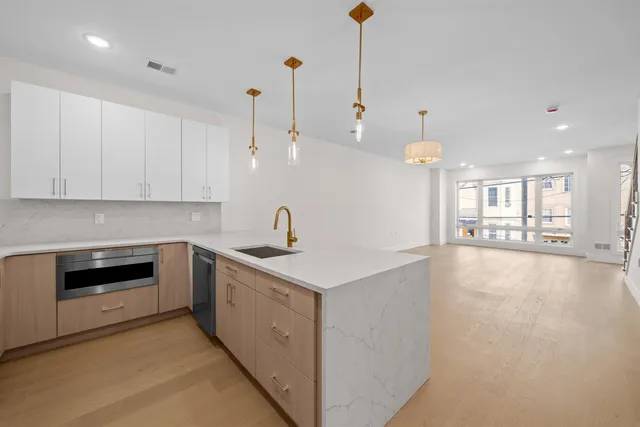 a kitchen with a stove sink and cabinets