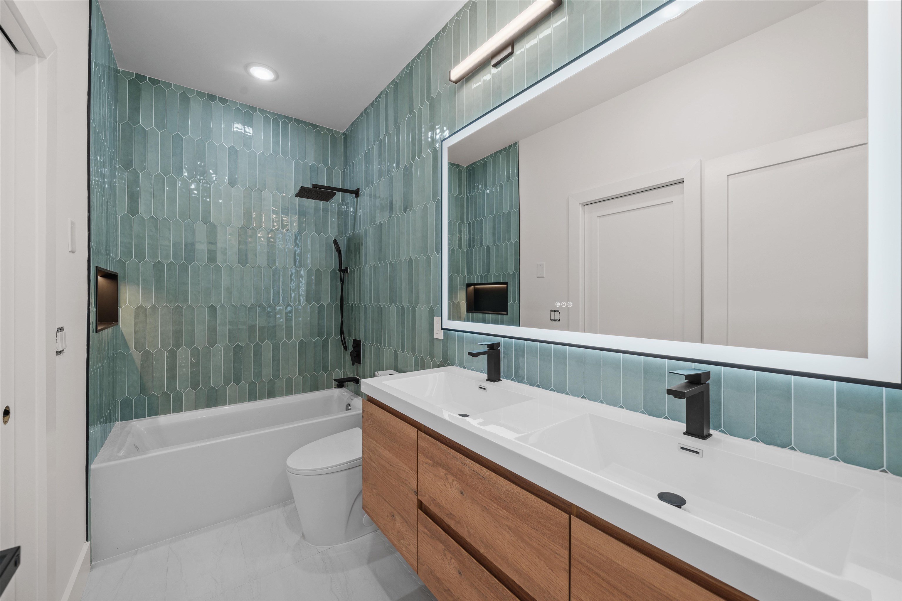 249.5 Halladay Street, Unit 2 Jersey City, NJ 07304 - Photo 13 of 36 a bathroom with a sink a toilet and shower