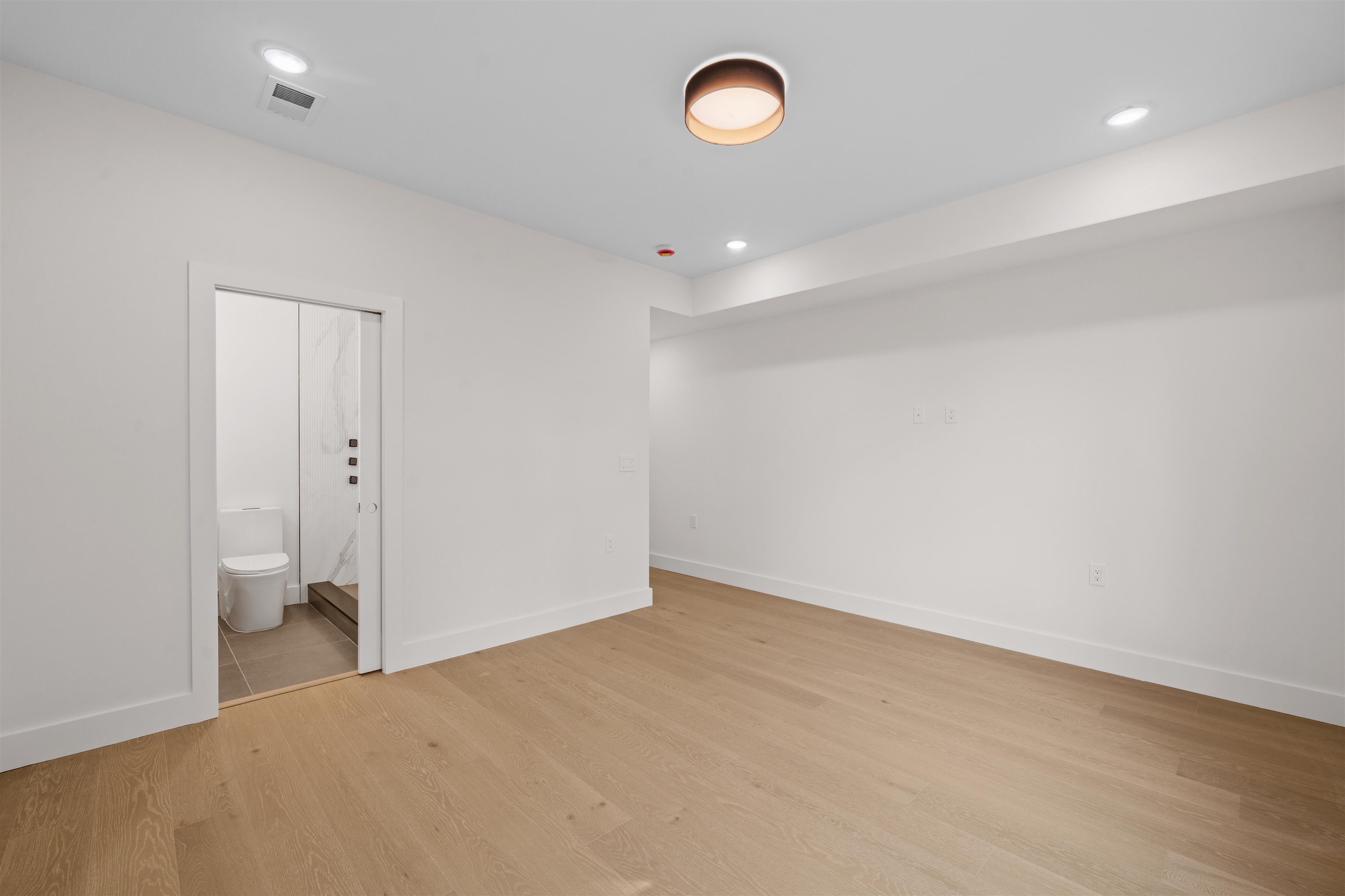 249.5 Halladay Street, Unit 2 Jersey City, NJ 07304 - Photo 18 of 36 wooden floor in an empty room with a window
