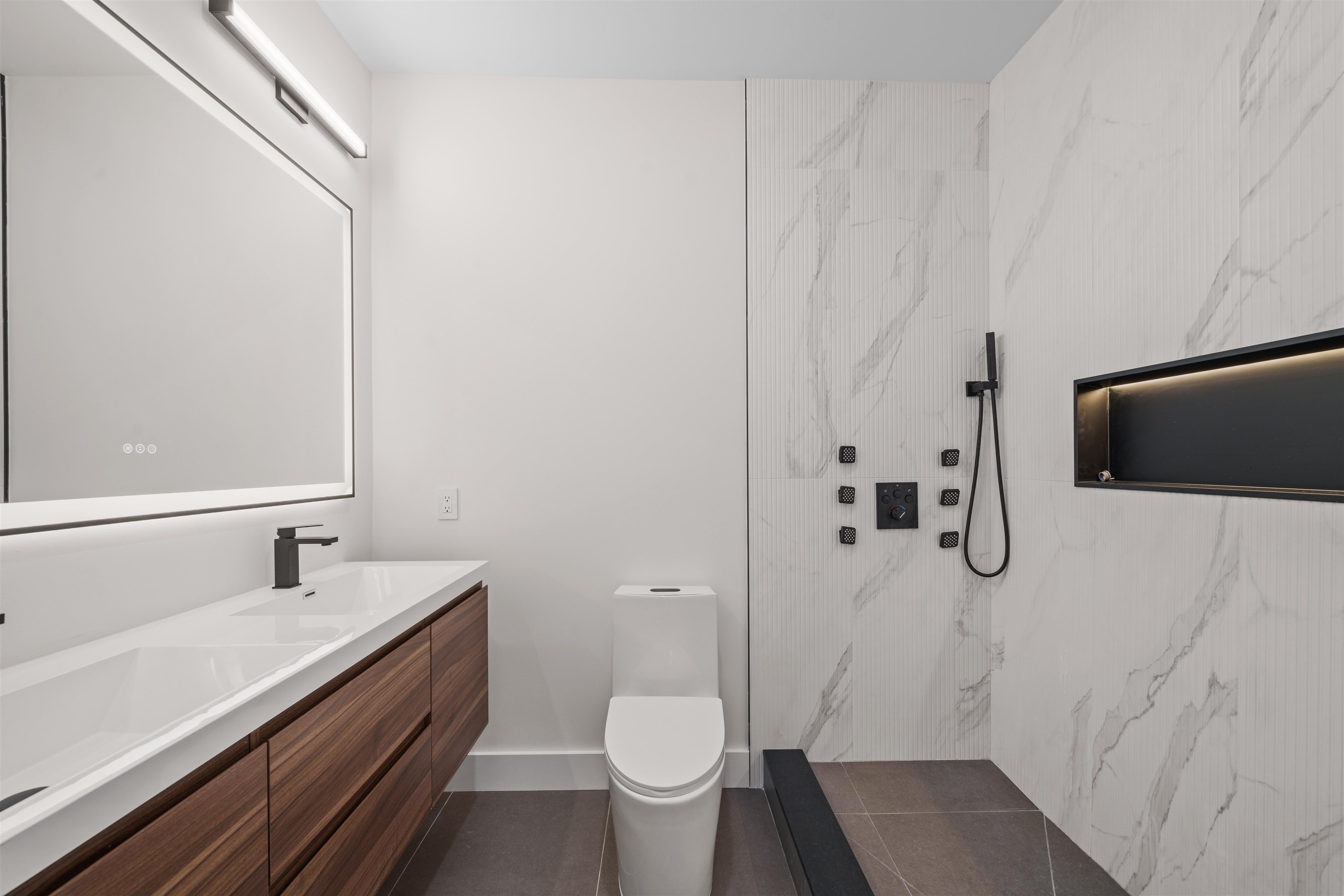 249.5 Halladay Street, Unit 2 Jersey City, NJ 07304 - Photo 21 of 36 a bathroom with a sink a toilet and shower