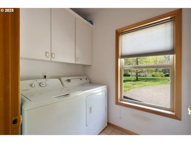 a view of backyard with table and chairs