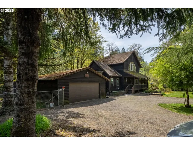 a view of a house with a yard and a tree