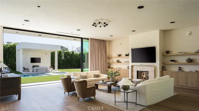 a living room with furniture potted plant and a large window