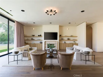 a large white kitchen with a window and stainless steel appliances
