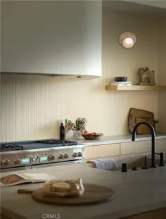 a kitchen with a sink and chairs