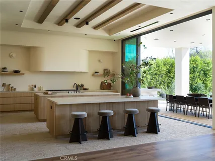 a kitchen with stainless steel appliances granite countertop a sink and wooden cabinets
