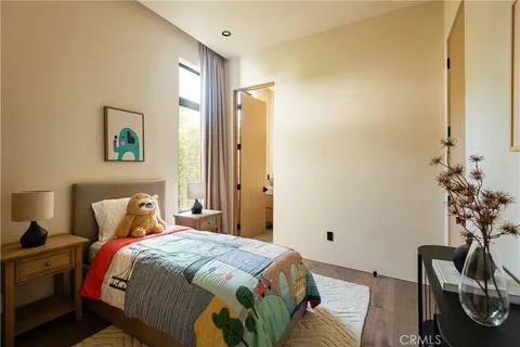 a living room with a balcony a bed and a fireplace