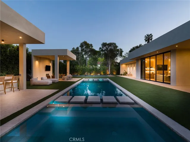 a swimming pool view with a outdoor seating space