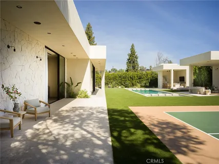 a living room with furniture and a floor to ceiling window