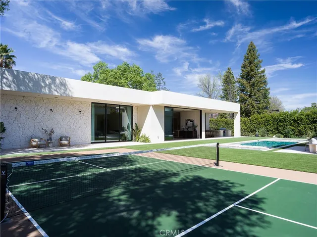 a view of a house with backyard and sitting area
