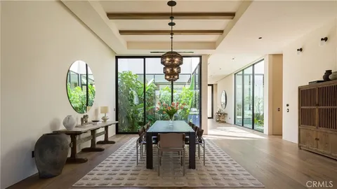 a view of a dining room with furniture wooden floor and chandelier