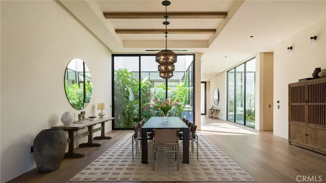 a view of a dining room with furniture wooden floor and chandelier