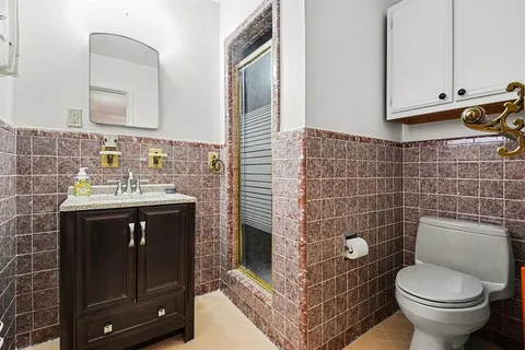 a bathroom with a sink vanity and toilet