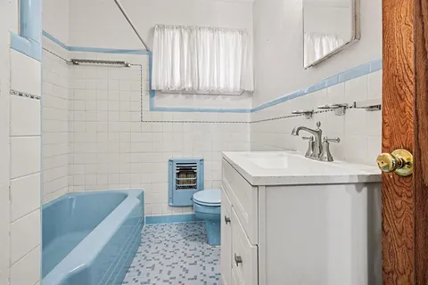 a bathroom with a sink a toilet and bathtub