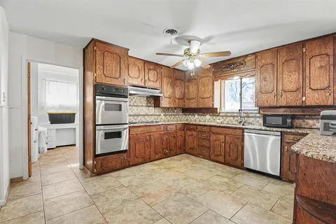 a kitchen with stainless steel appliances granite countertop a stove cabinets and a refrigerator