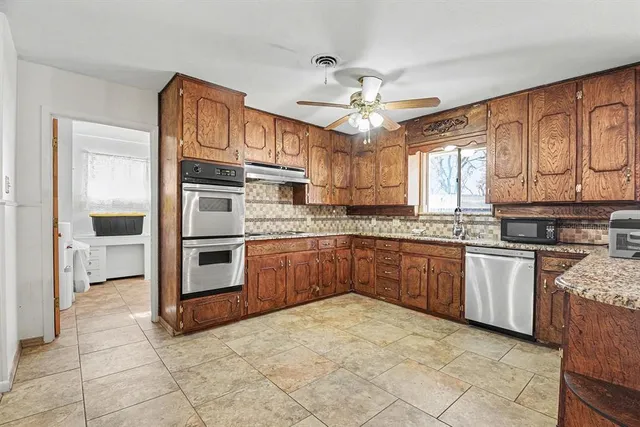 a kitchen with stainless steel appliances granite countertop a stove cabinets and a refrigerator