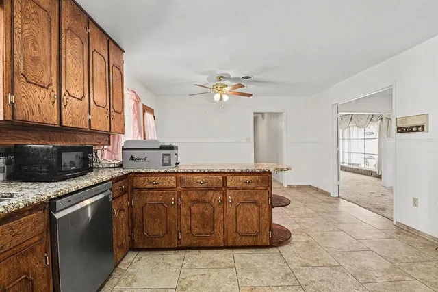 a kitchen with stainless steel appliances granite countertop a sink and cabinets