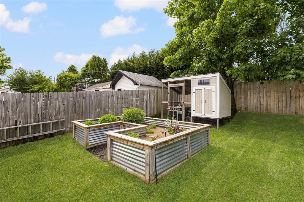 69 Denver Street Fall River, MA 02721 - Photo 5 of 35 a view of a backyard with a tub and trees