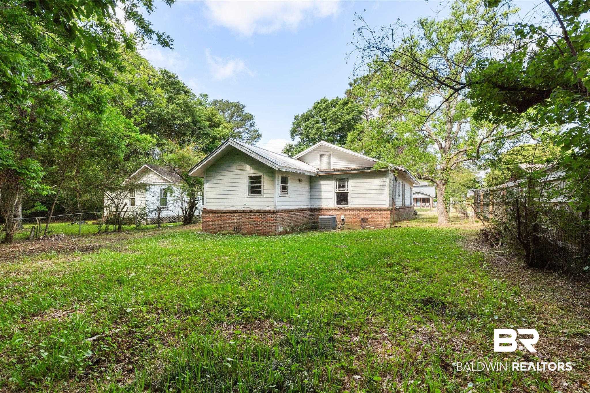 672 Burden Street Mobile, AL 36607 - Photo 17 of 20 Rear view of property featuring central AC unit and brick siding