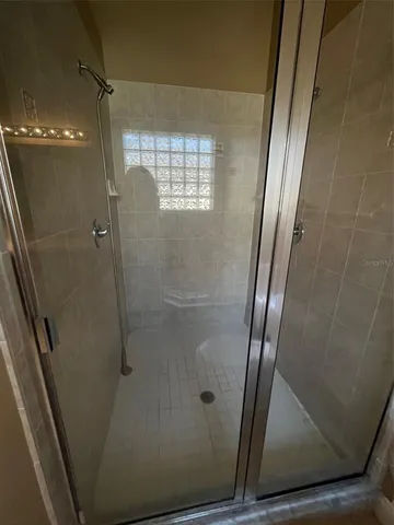 a bathroom with a glass door shower
