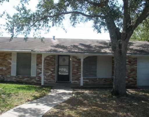 a view of a house with a tree in front of it