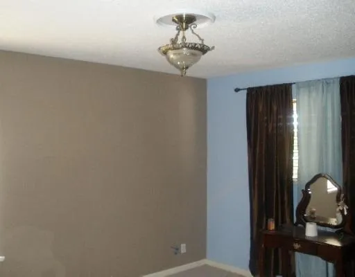 a view of a hallway with a chandelier