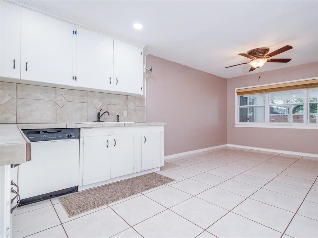 4002 Austin Avenue Brownwood, TX 76801 - Photo 8 of 34 a kitchen with a sink cabinets and window