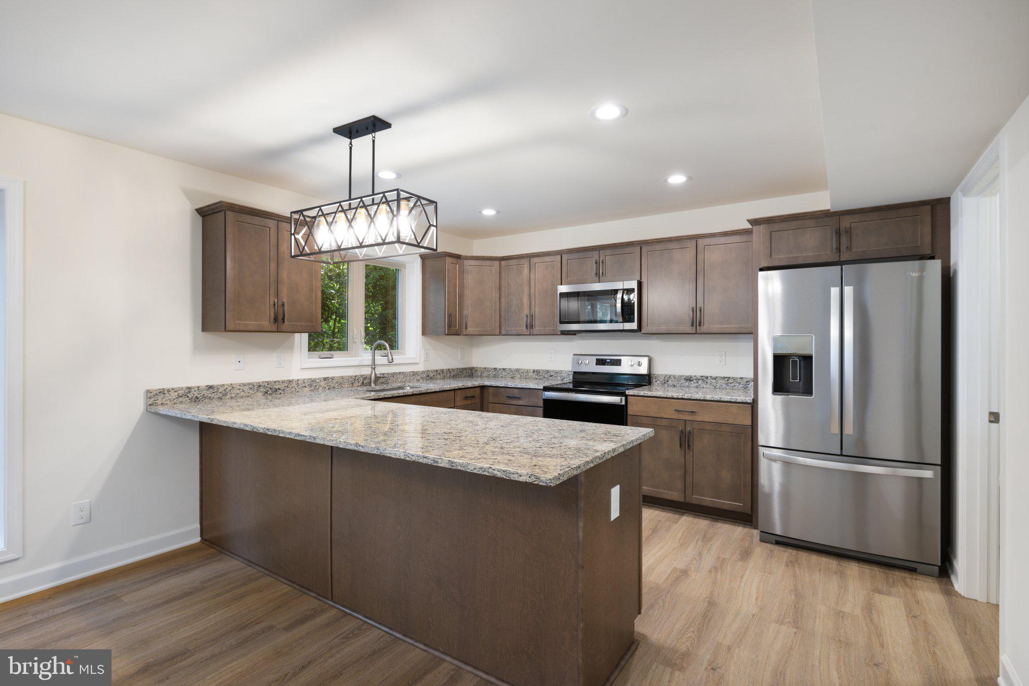 141 Oak View Street Culpeper, VA 22701 - Photo 12 of 46 a kitchen with kitchen island granite countertop stainless steel appliances a sink refrigerator and microwave
