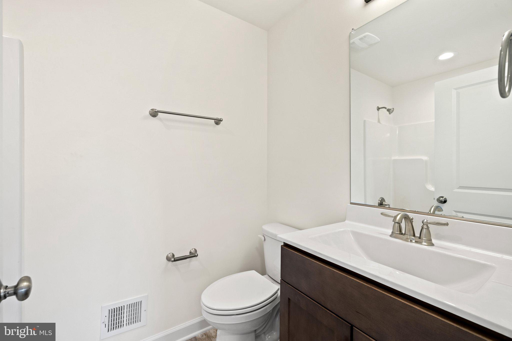 141 Oak View Street Culpeper, VA 22701 - Photo 43 of 46 a bathroom with a toilet a sink a mirror and vanity