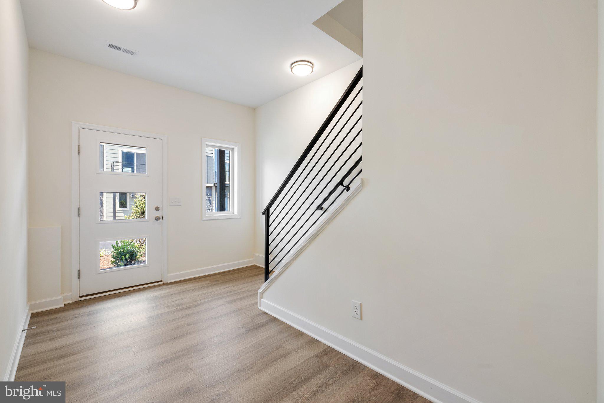 141 Oak View Street Culpeper, VA 22701 - Photo 6 of 46 a view of an empty room with wooden floor and a window