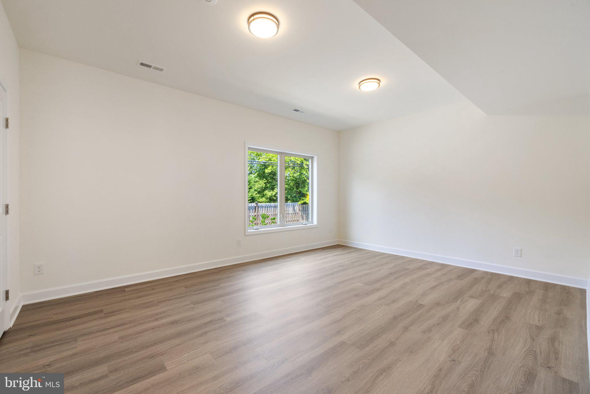 141 Oak View Street Culpeper, VA 22701 - Photo 10 of 46 an empty room with wooden floor and windows