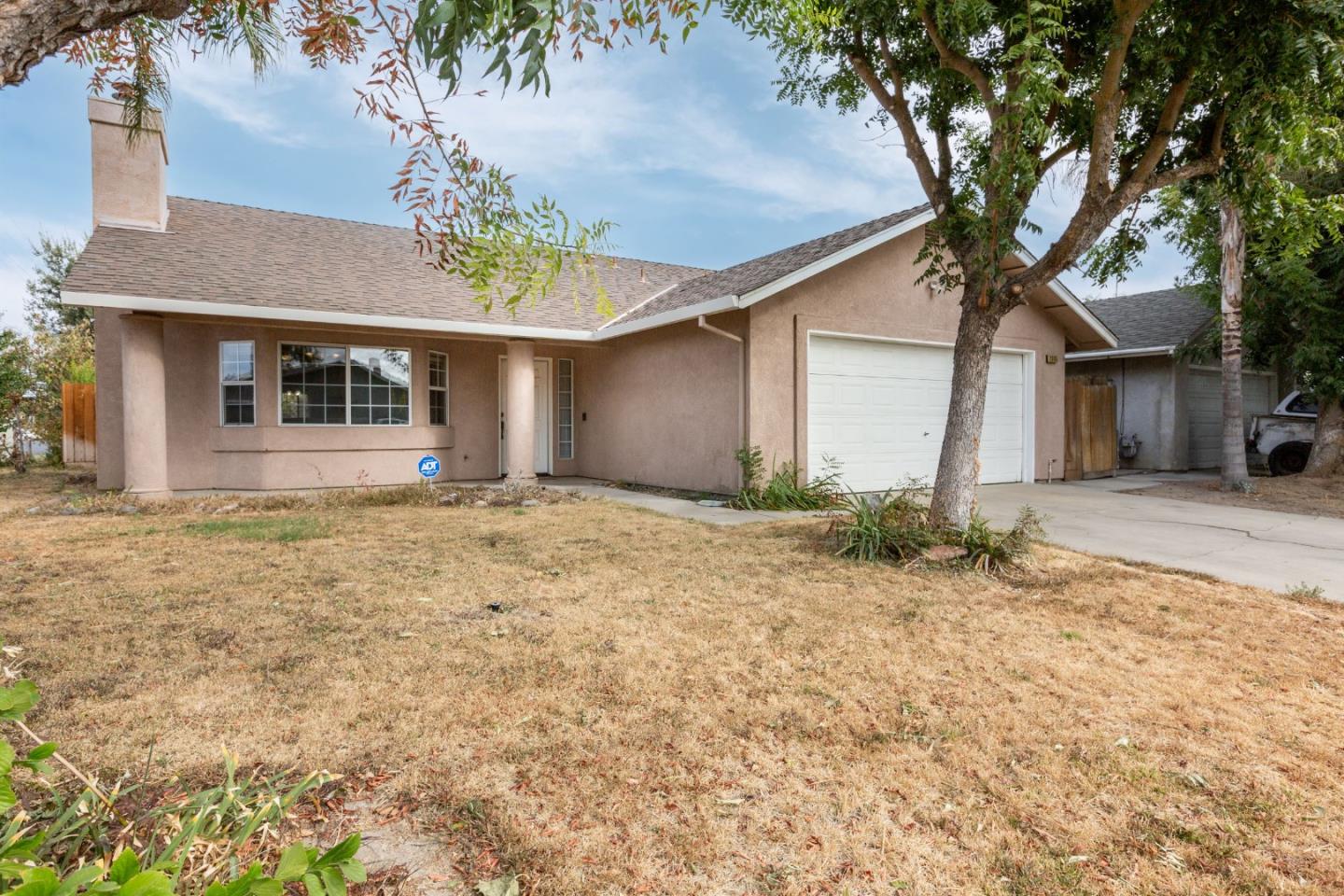 2085 Roth Court Turlock, CA 95380 - Photo 2 of 26 a front view of a house with a yard and garage