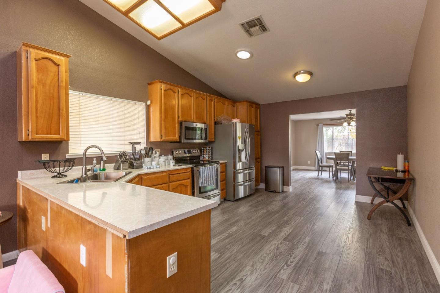 2085 Roth Court Turlock, CA 95380 - Photo 11 of 26 a kitchen with a sink a counter top space and stainless steel appliances