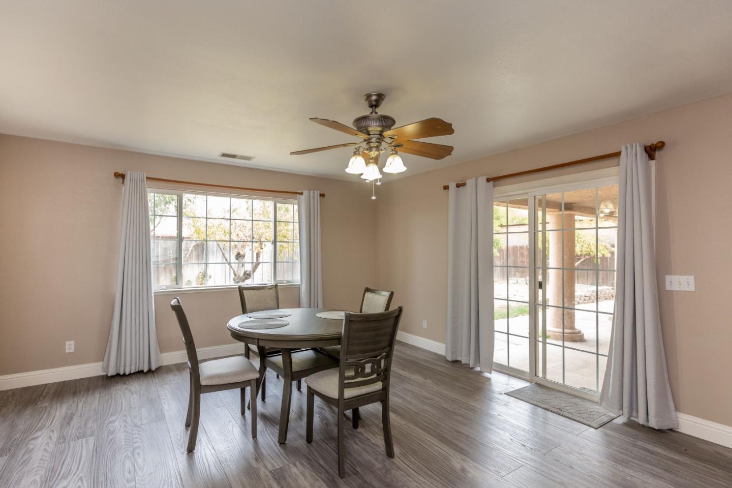 2085 Roth Court Turlock, CA 95380 - Photo 13 of 26 a dining room with furniture a chandelier and wooden floor