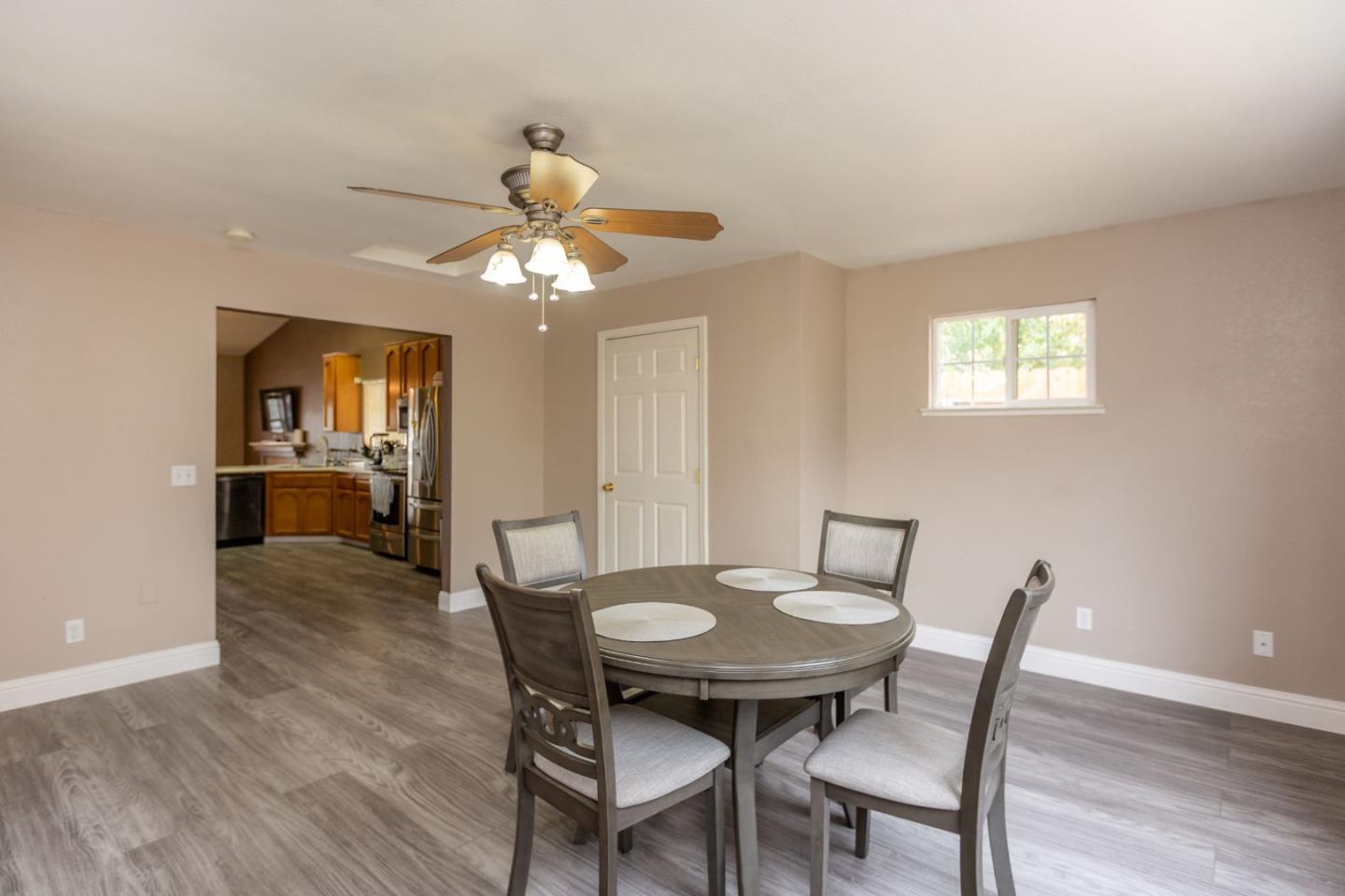 2085 Roth Court Turlock, CA 95380 - Photo 15 of 26 a view of a dining room with furniture and wooden floor