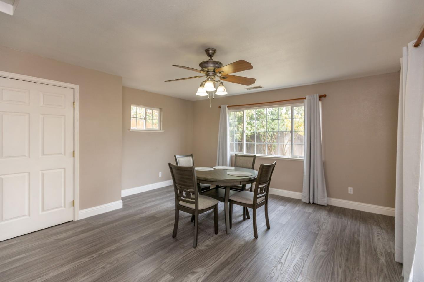 2085 Roth Court Turlock, CA 95380 - Photo 16 of 26 a view of a dining room with furniture window and wooden floor