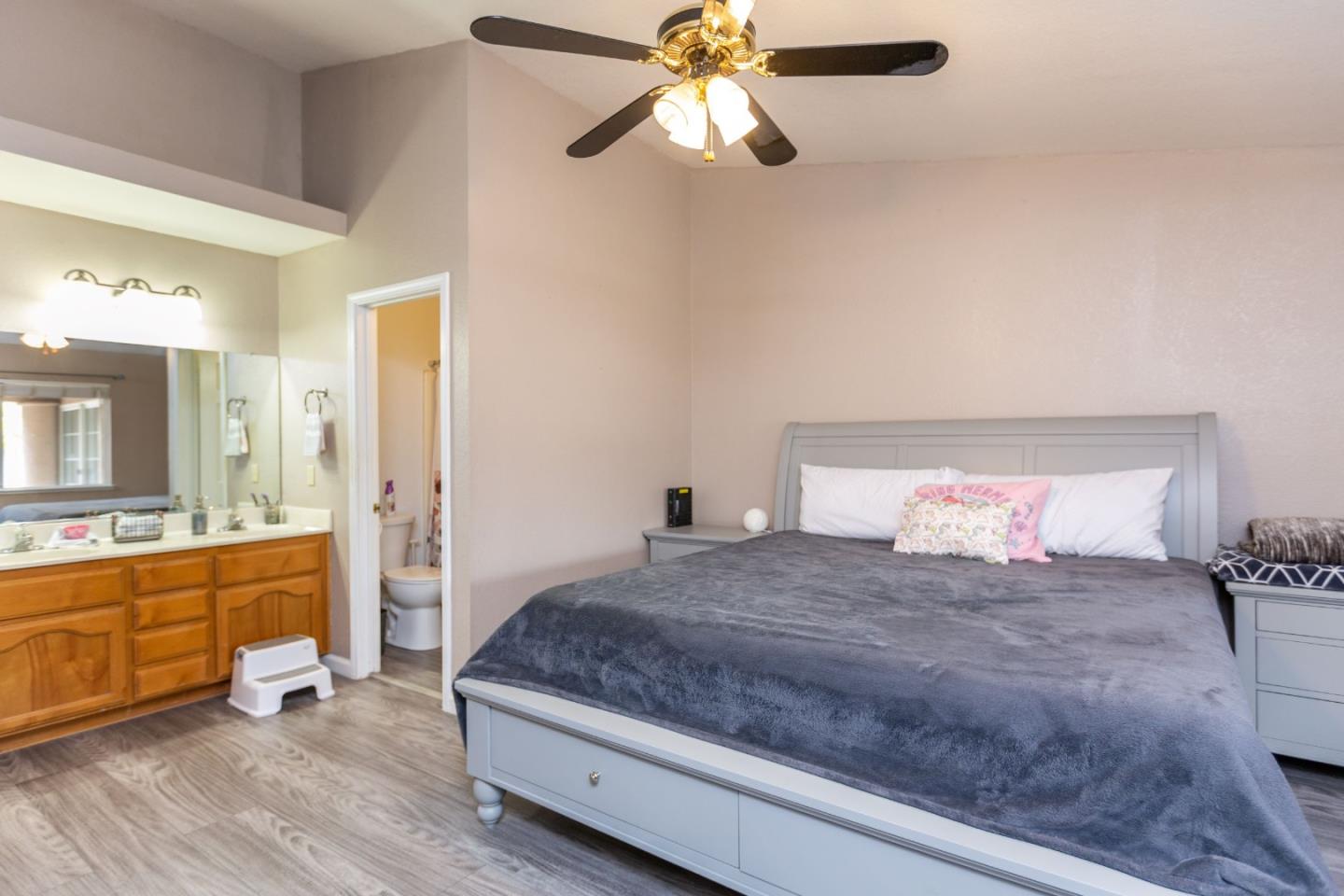 2085 Roth Court Turlock, CA 95380 - Photo 18 of 26 a bedroom with a large bed and a chandelier